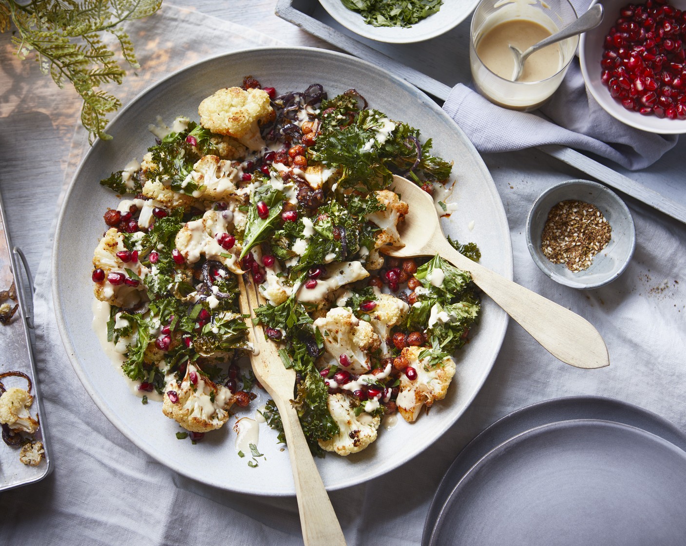 step 4 Heat a drizzle of olive oil in a frying pan and add the chickpeas (1 tin) and paprika (2 tsp). Cook until slightly crispy. Add to a bowl and top with the cauliflower, kale (125 g) and dressing. Garnish with the pomegranate seeds (2 tbsp) and parsley (1 handful).