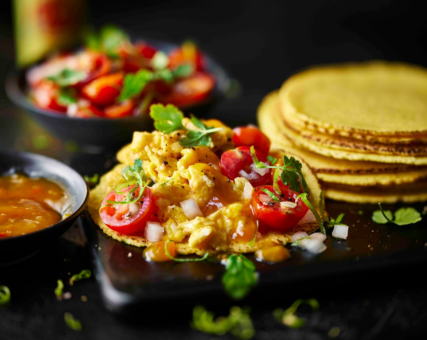 step 3 Heat a splash of oil in a non-stick frying pan over a medium heat, then season the eggs (8) with salt and pepper. Add the eggs to a pan and cook, stirring, for 3-4 minutes until scrambled to your liking. Serve the tacos topped with the eggs, tomato salsa and hot sauce (as needed).
