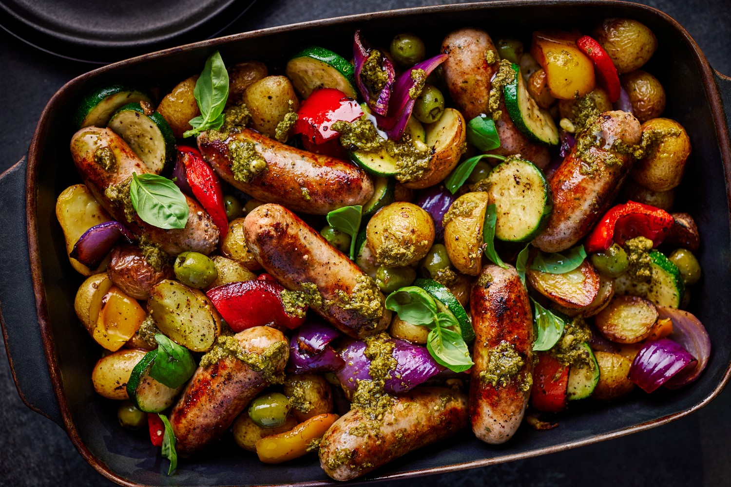 Italian-style sausage, roasted veg and pesto traybake recipe