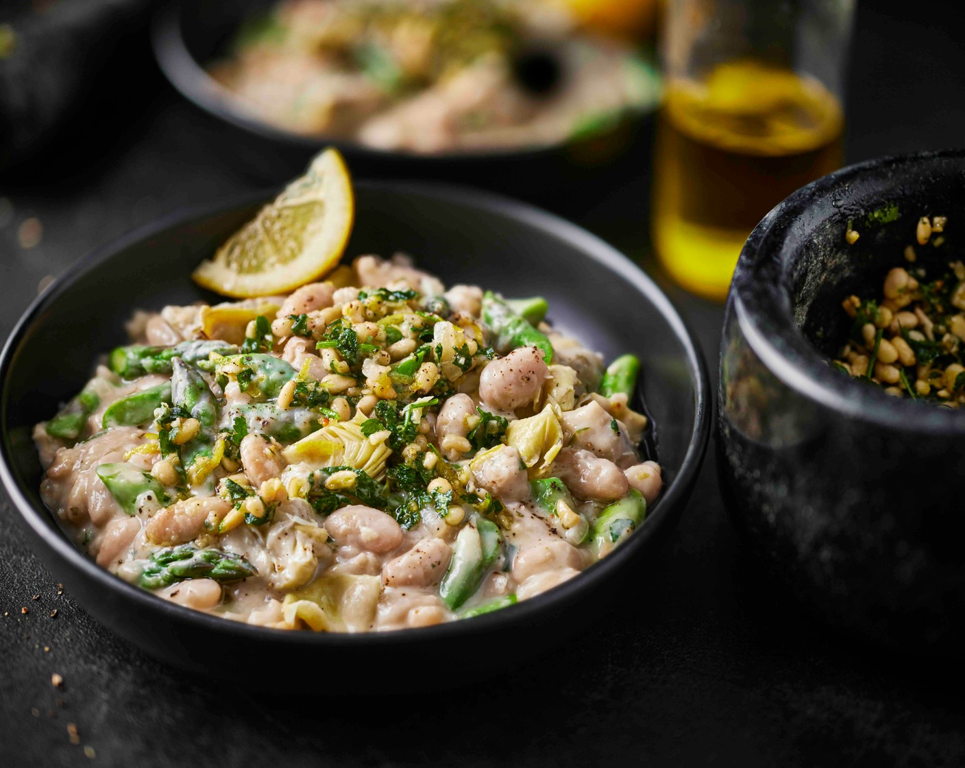 step 5 Spoon the beans into bowls and top with the lemon and pine nut pesto.
