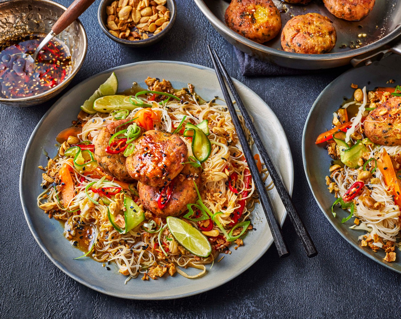 step 6 Heat 1 tbsp vegetable oil in a large frying pan and cook the fishcakes for 4 minutes on each side, until golden and cooked through. Top the noodle salad with the peanuts (2 tbsp) and crispy onions (2 tbsp) and serve alongside the fishcakes and lime wedges (1).
