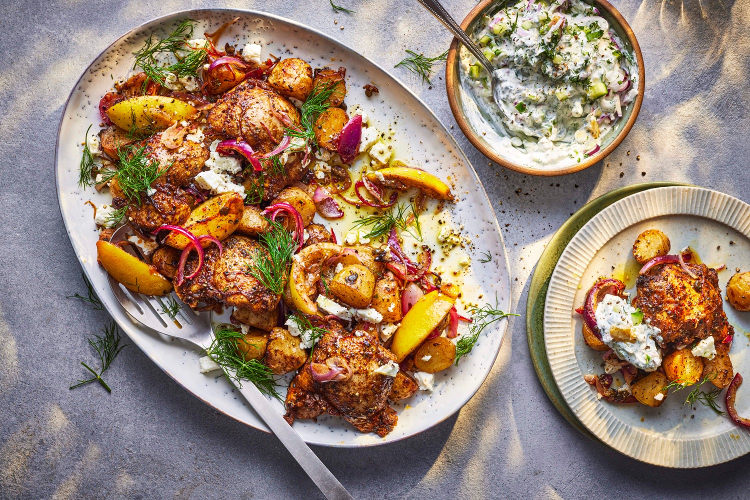 Greek lemon chicken and potato barbecue platter with tzatziki