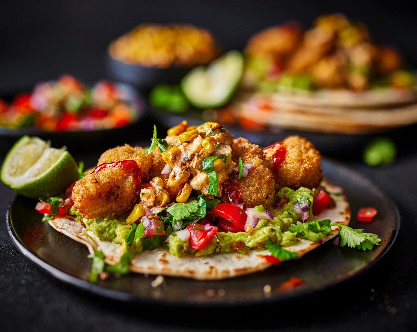 step 7 Top the crispy tacos with the guacamole (100 g), cod bites, pico de gallo and some naga chilli sauce (3 tbsp), if you’d like. Serve with the corn salsa, a wedge of lime (1) and an extra sprinkling of coriander, if you like.