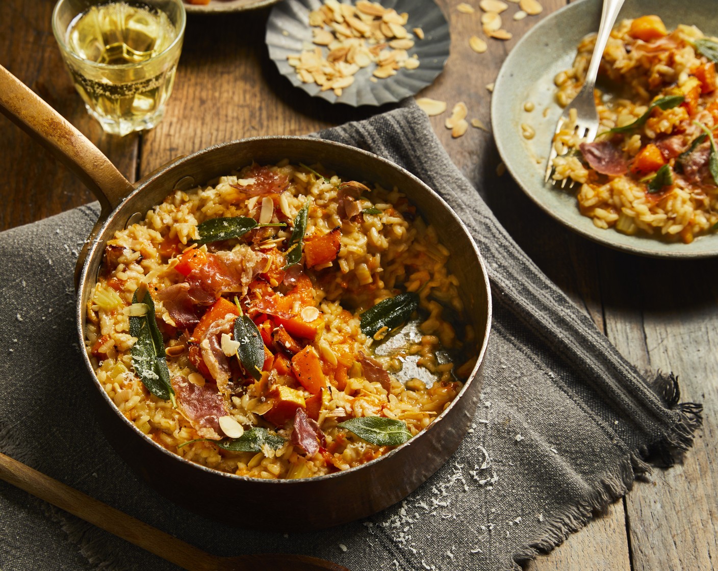 step 12 Serve the risotto topped with the remaining roasted pumpkin, a sprinkling of parmesan, the toasted almonds, the sage and the crispy pieces of Parma ham. Season to taste.