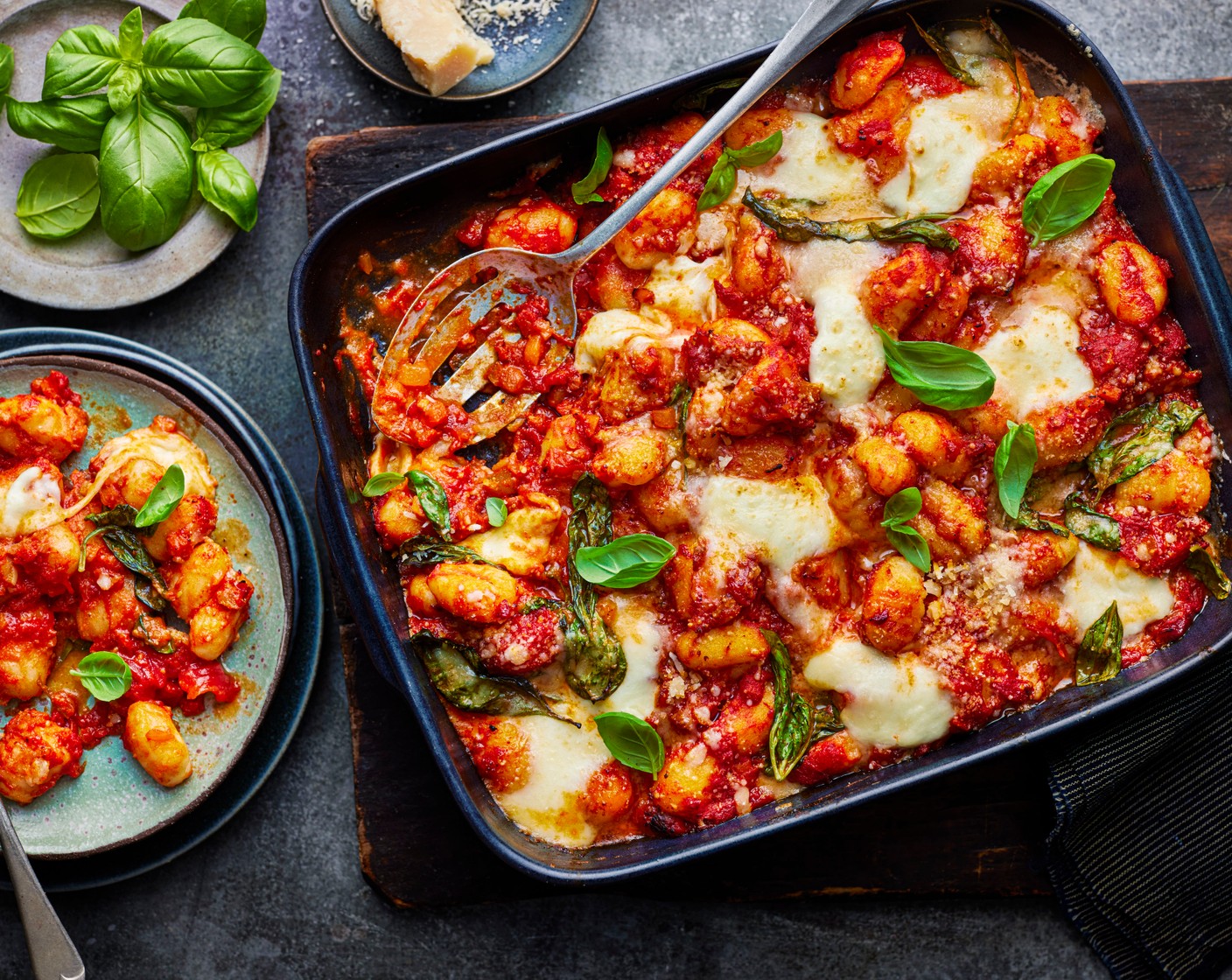 step 3 Preheat the oven to 180°C fan. Stir the gnocchi (500 g) into the sauce. Tear over the mozzarella (1) and grate over the parmesan (50 g). Bake for 20 minutes, until the mozzarella is bubbling and golden. Finish by scattering over the reserved basil leaves.
