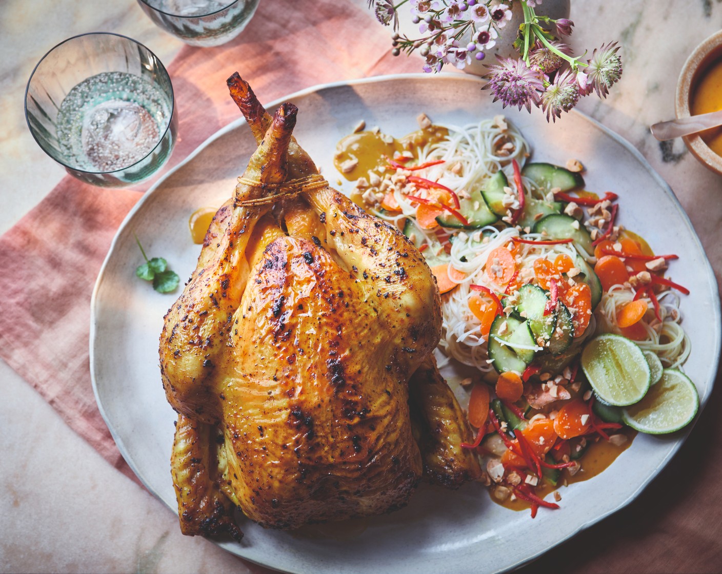 step 5 When the chicken is cooked, toss the salad with the noodles and coriander (25 g) and top with the peanuts (1 handful). Serve the chicken with the noodle salad and satay sauce.