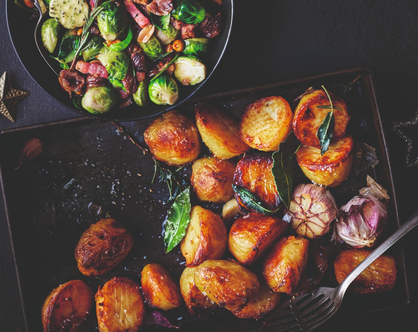 step 5 Roast for 20-25 minutes, then remove from the oven and turn over, adding a splash more oil or fat if needed. Add herbs such as rosemary (1 handful), bay leaves, sage and thyme, plus a whole bulb of M&S Remarksable Value garlic (1), if you like. Roast for a further 20-25 minutes – potato perfection!