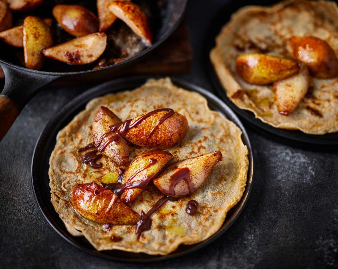 step 6 Serve the crepes with the caramelised pears and chocolate sauce (2 tbsp) drizzled on top.