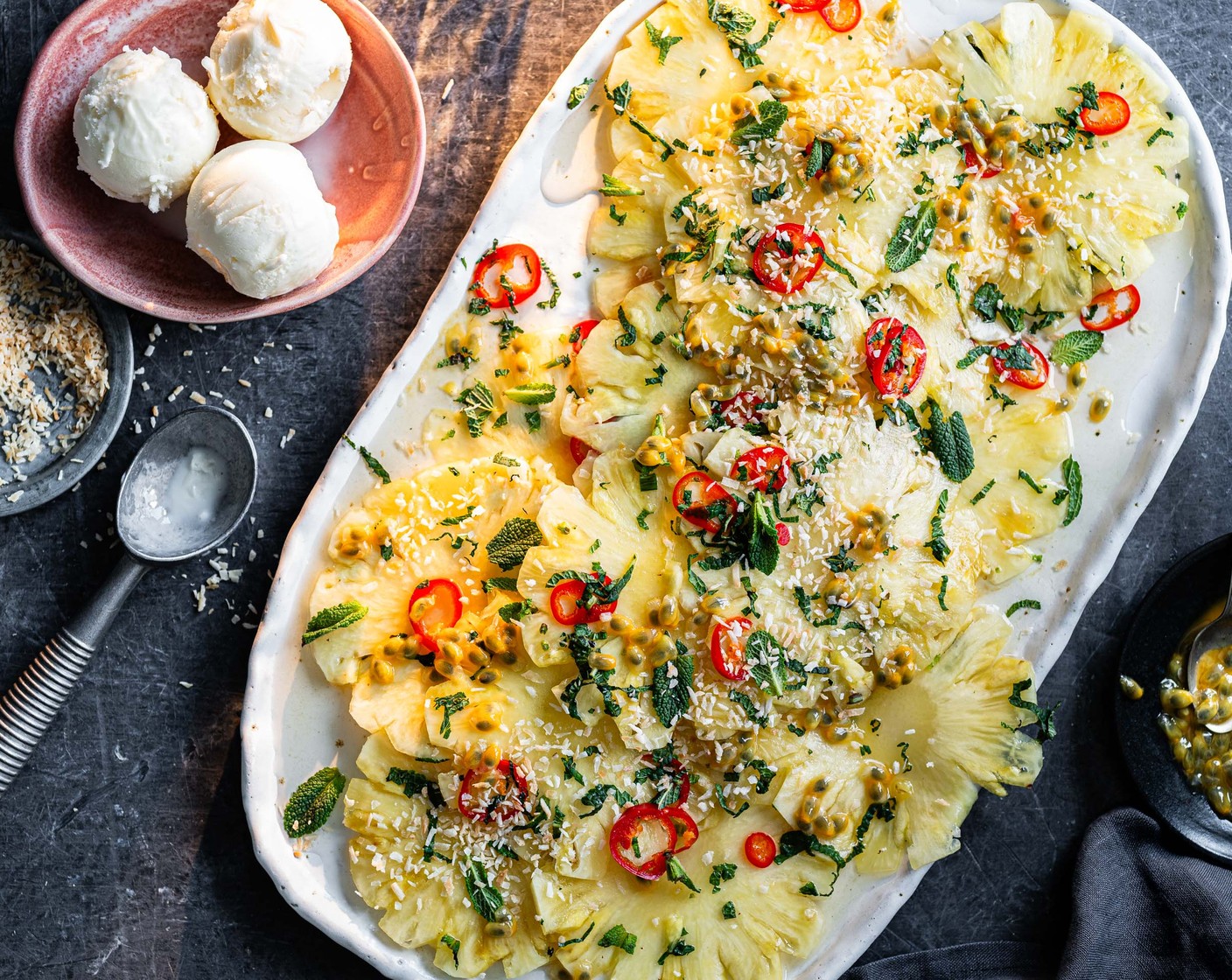 step 3 When ready to serve, top your pineapple with the seeds from the passion fruits (3), sprinkle over a little toasted desiccated coconut (1 tbsp) and serve with a scoop of M&S Collection coconut luxury ice cream (4 scoops). Garnish with fresh mint leaves.