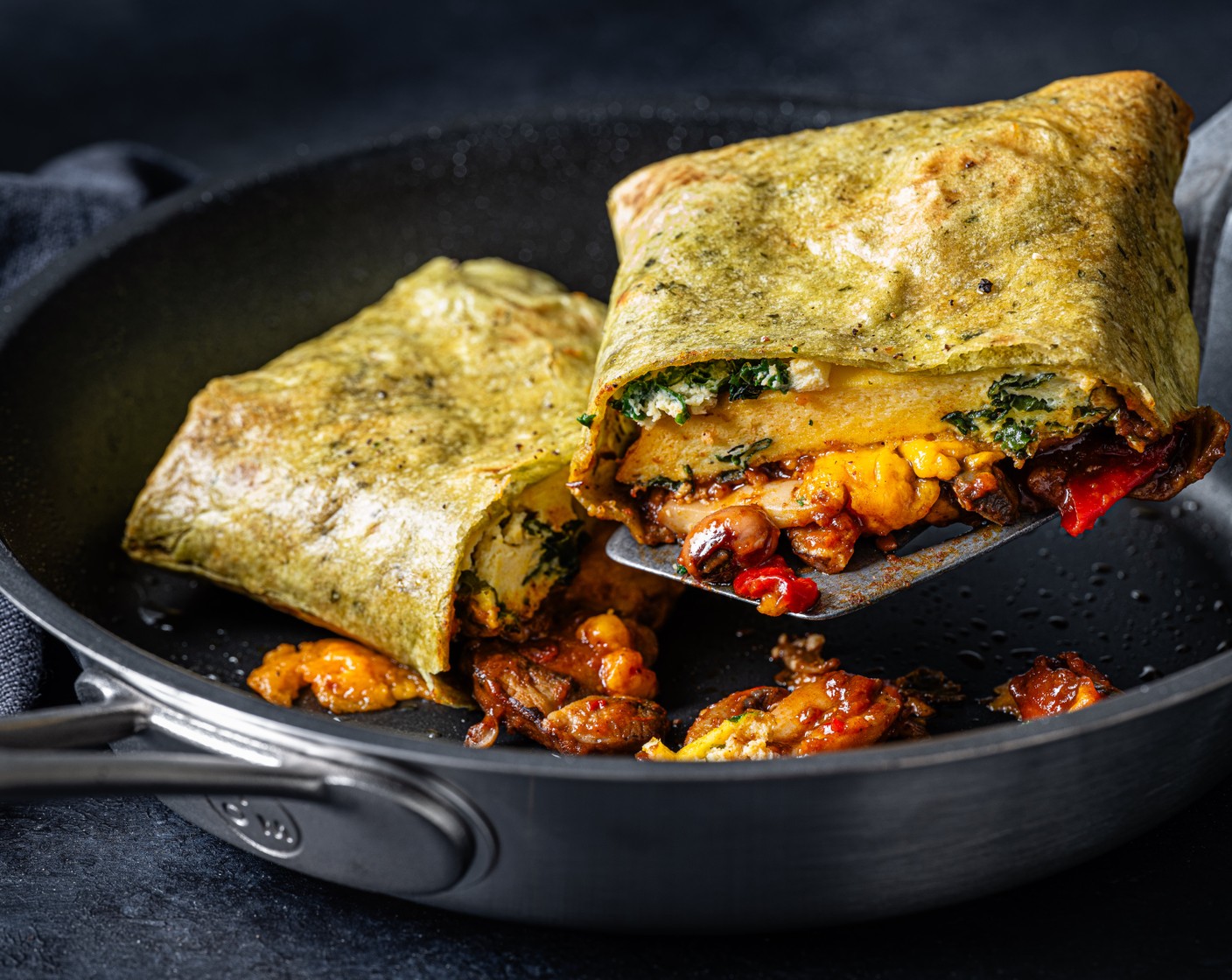 step 11 Pan-fry the burritos for around 2-3 minutes, seal-side down, and then flip and cook on the other side for a further 2-3 minutes, until the wraps are golden brown and the cheese has melted.