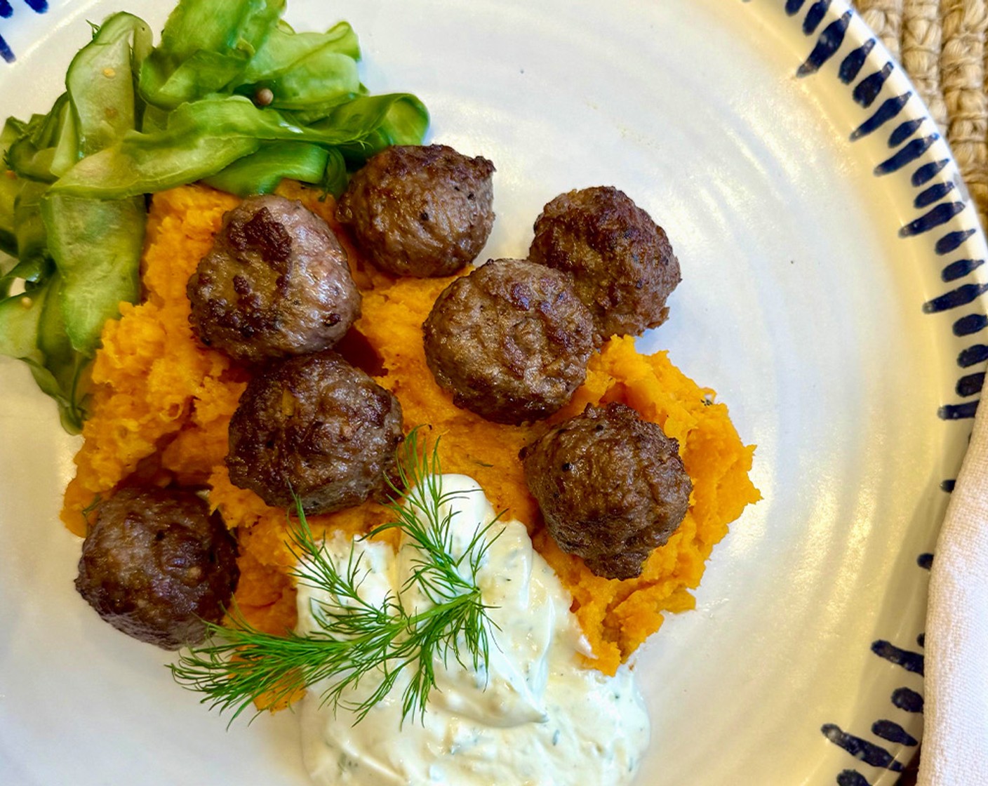 step 10 Serve the meatballs with the sweet potato mash, the yogurt sauce and the quick-pickled cucumbers.