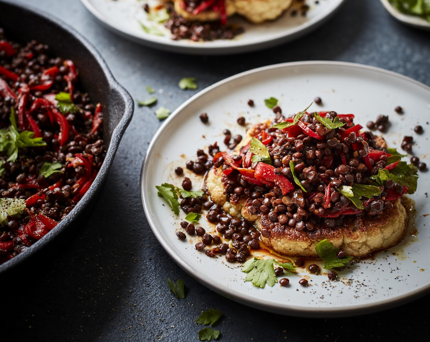 step 4 Remove the roasted cauliflower steaks from the oven and arrange on four serving plates. Divide the warmed pepper and lentil salsa over the steaks and scatter with parsley to serve.