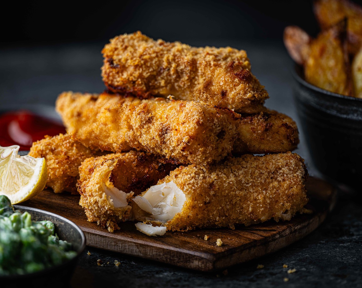step 9 Serve the fish fingers with the potato wedges and pea smash.