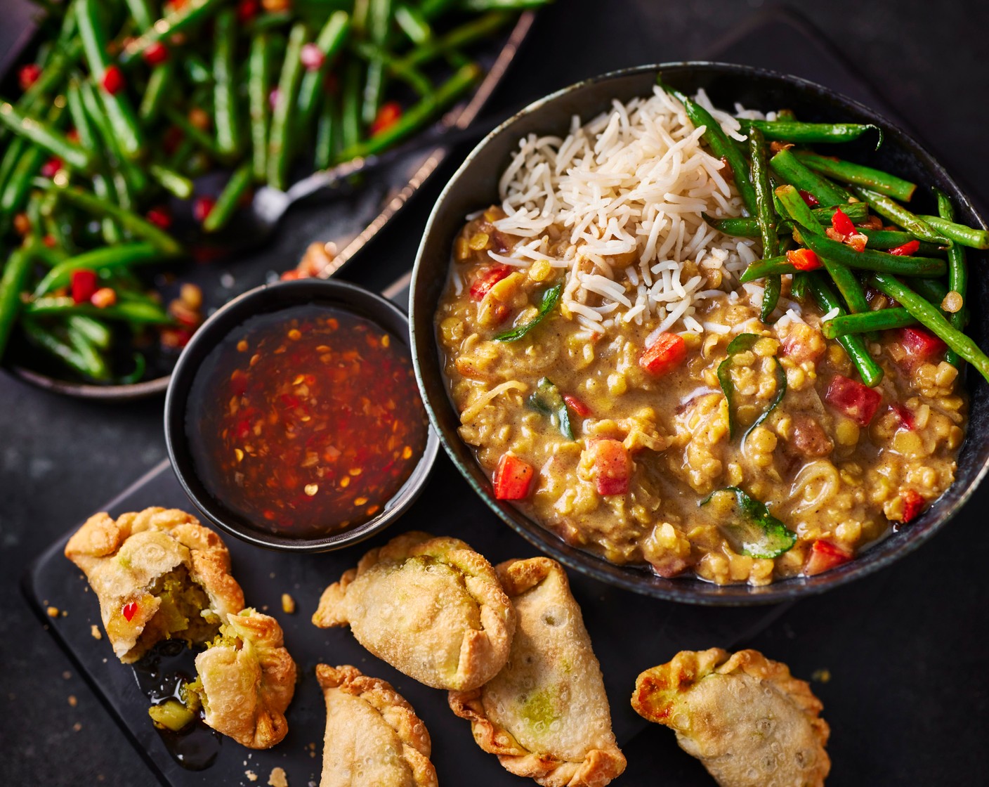 step 6 Serve in bowls with the rice, green beans, curry puffs and some sweet chilli sauce (4 tbsp) if you’d like.