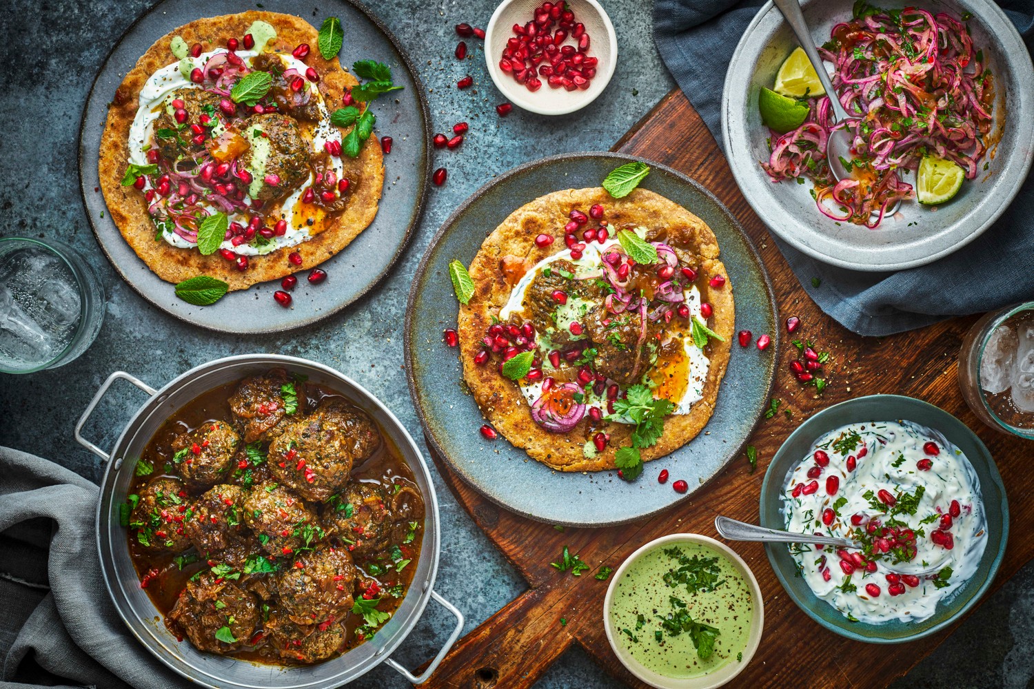 Lamb vhura with paratha, spicy onions, pomegranate raita, coriander chutney and lamb russa