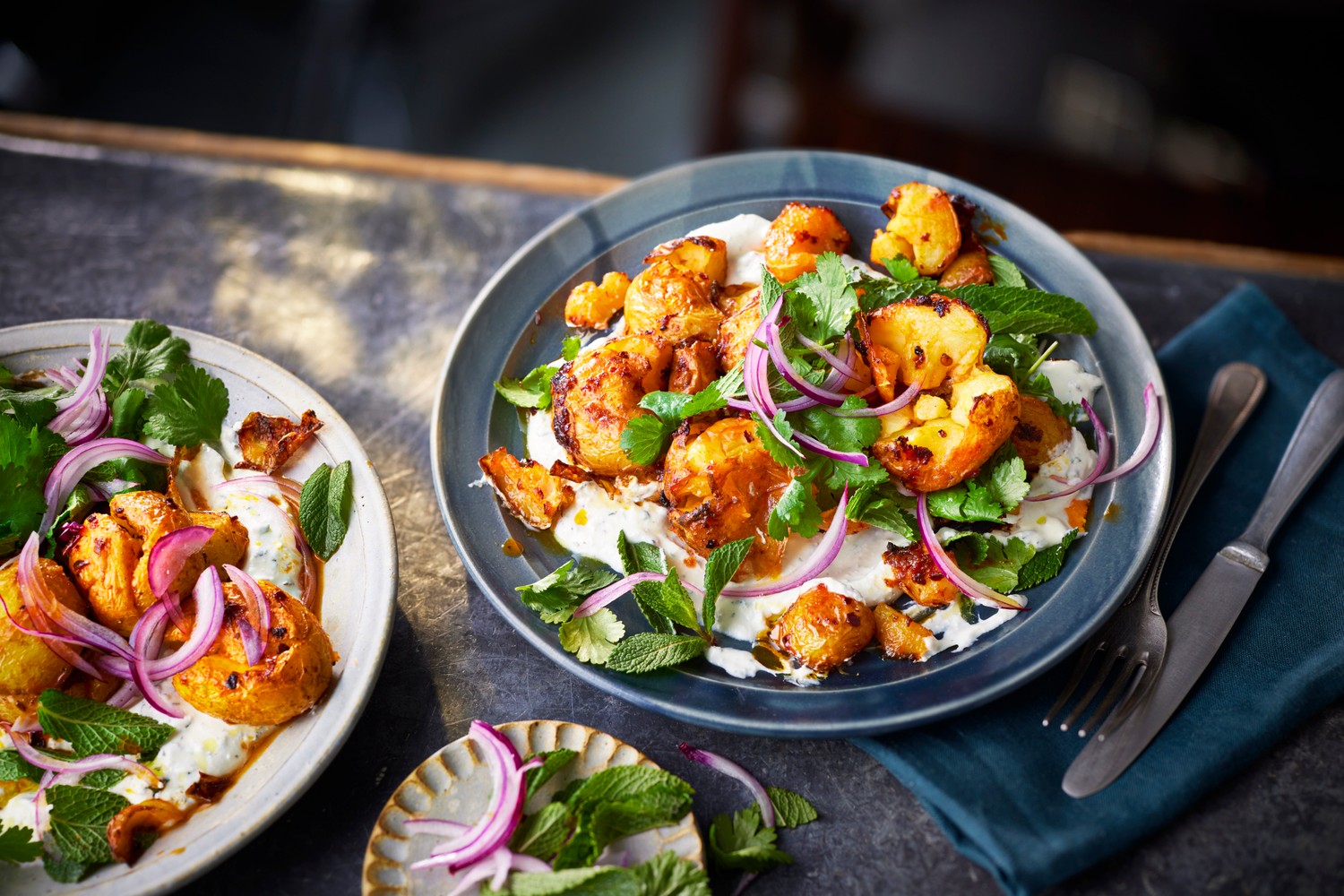 Harissa roasted potatoes with whipped feta and herb salad