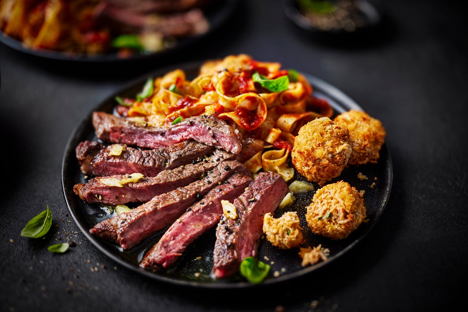 Ribeye steak with sugo pomodoro tagliatelle and crab bonbons