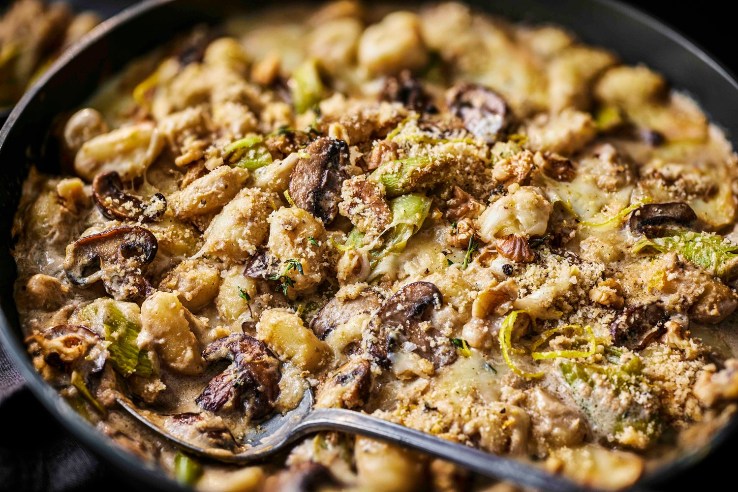 Creamy mushroom and taleggio baked gnocchi with a crunchy walnut topping