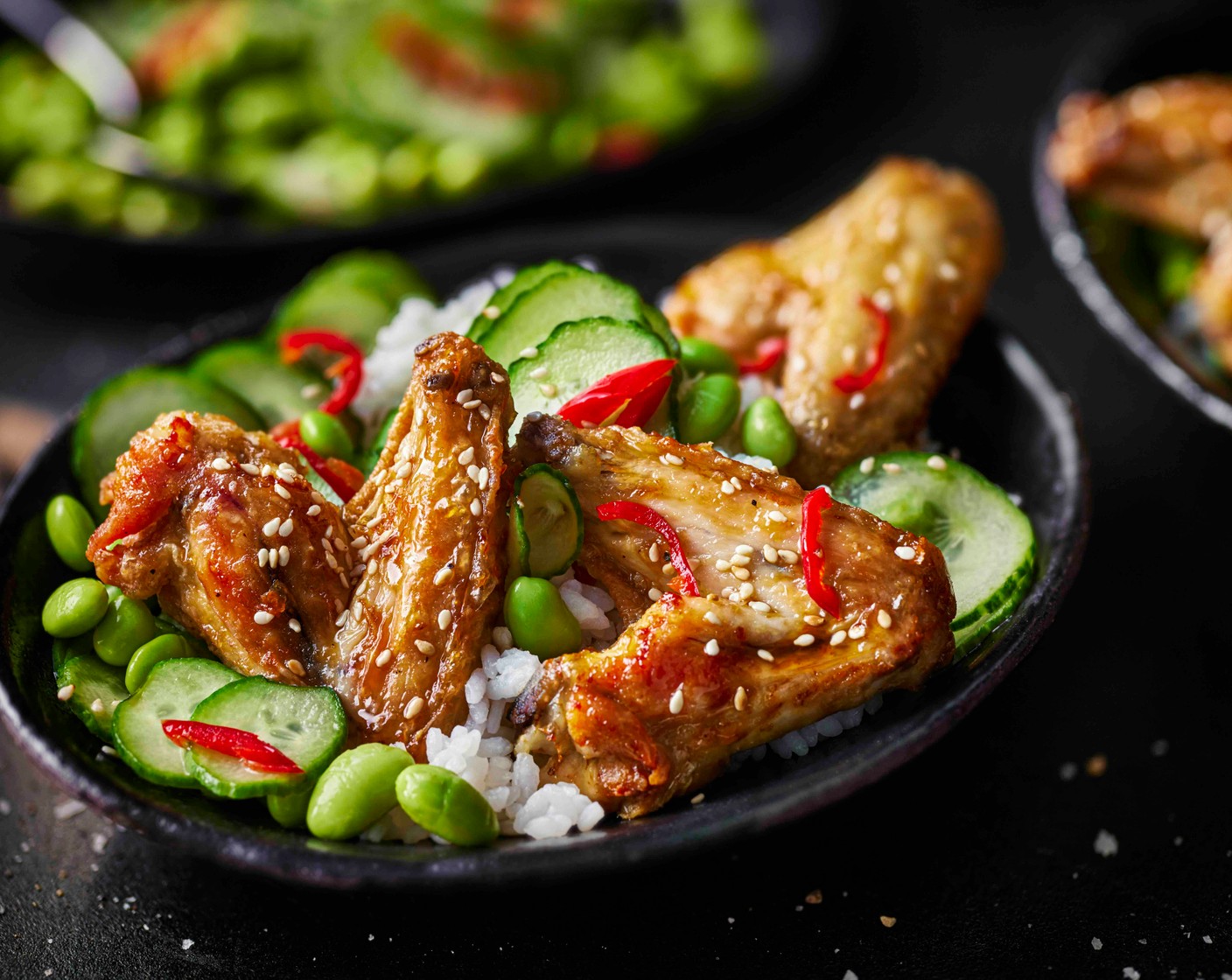 step 6 Spoon the rice into bowls. Toss the hot wings in the sauce, then serve on top of the rice with the cucumber salad. Scatter over the sesame seeds (1 tbsp) to finish.