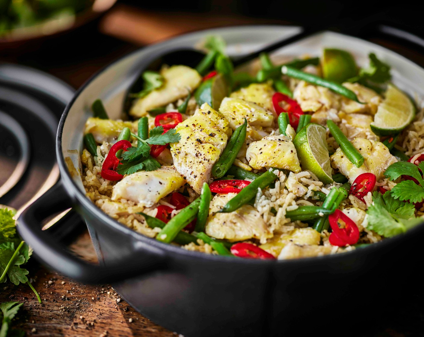 step 4 Turn off the heat, garnish with coriander (2 tbsp) and chilli (1) and serve with lime wedges (1).