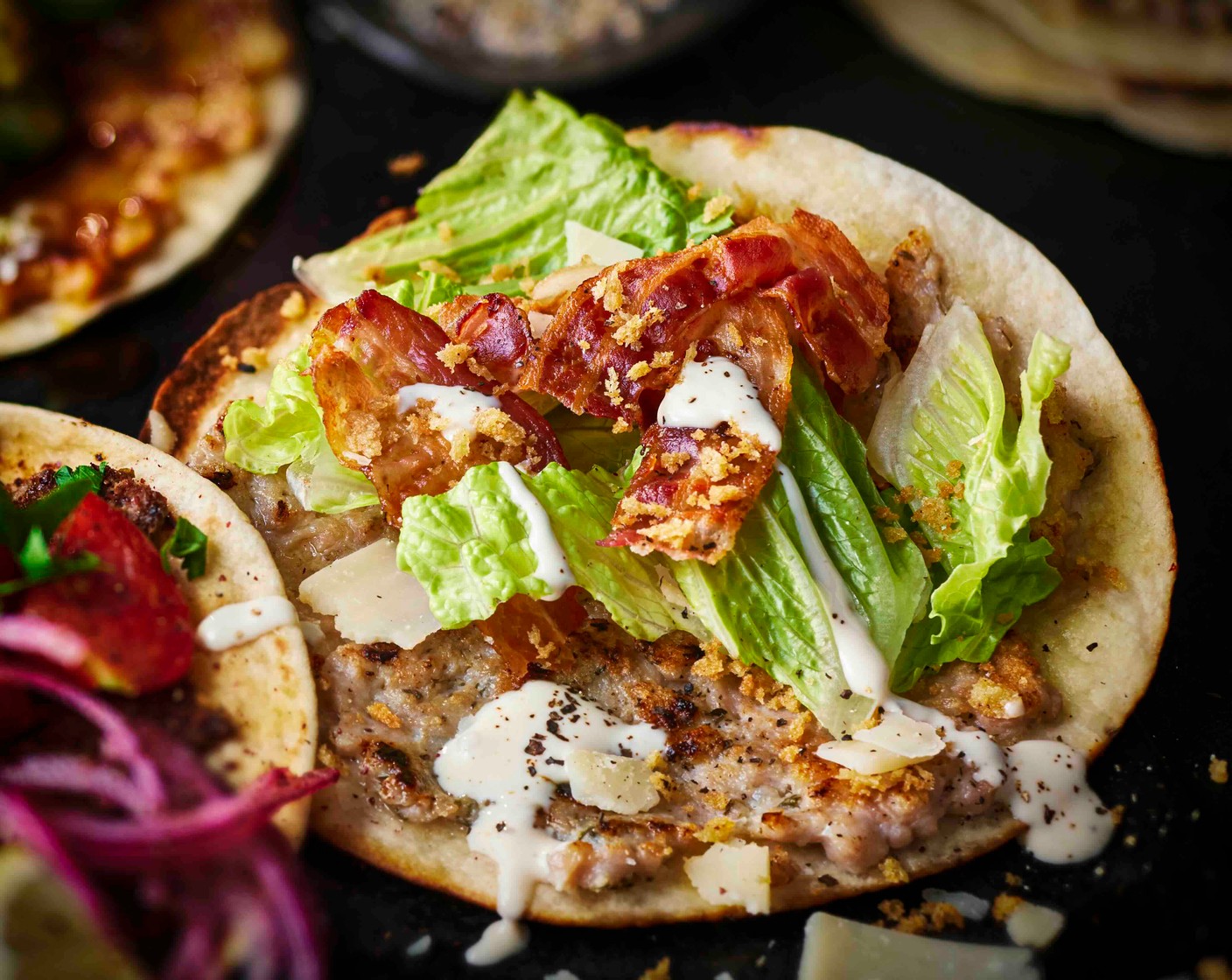 step 6 Top each taco with lettuce (1/2), chopped bacn, Caesar dressing (as needed), panko breadcrumbs and parmesan (as needed).