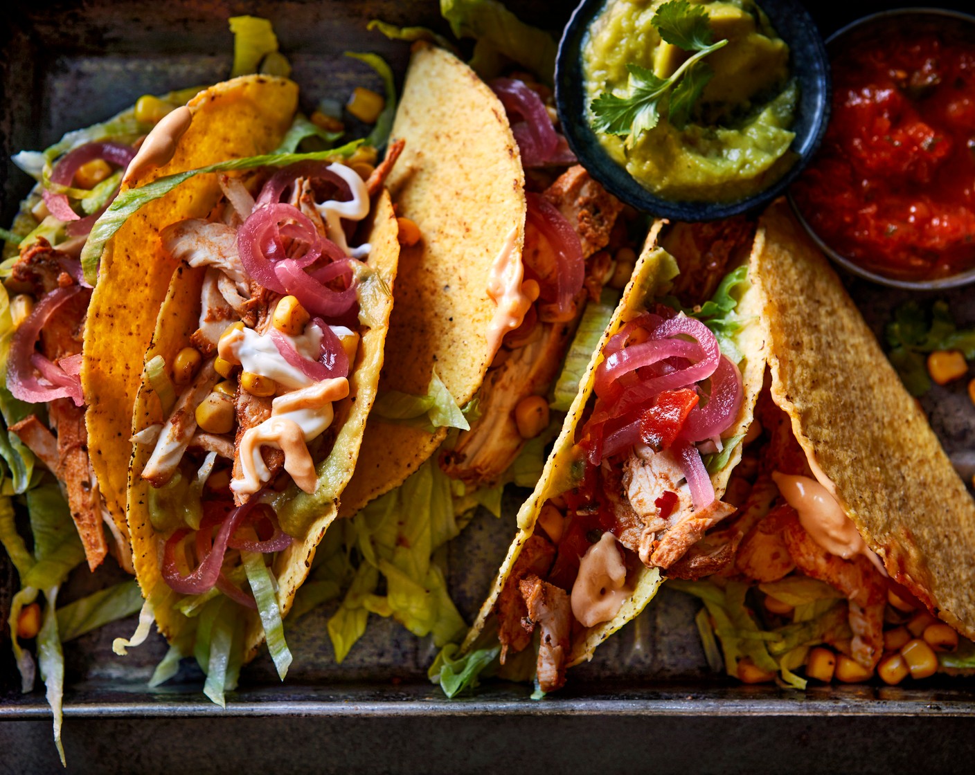 step 2 Fill the taco shells with the lettuce (1 head), corn, chicken (1 pack) and dips (to taste). Top with the pickled red onions (1 tbsp), then tuck in.