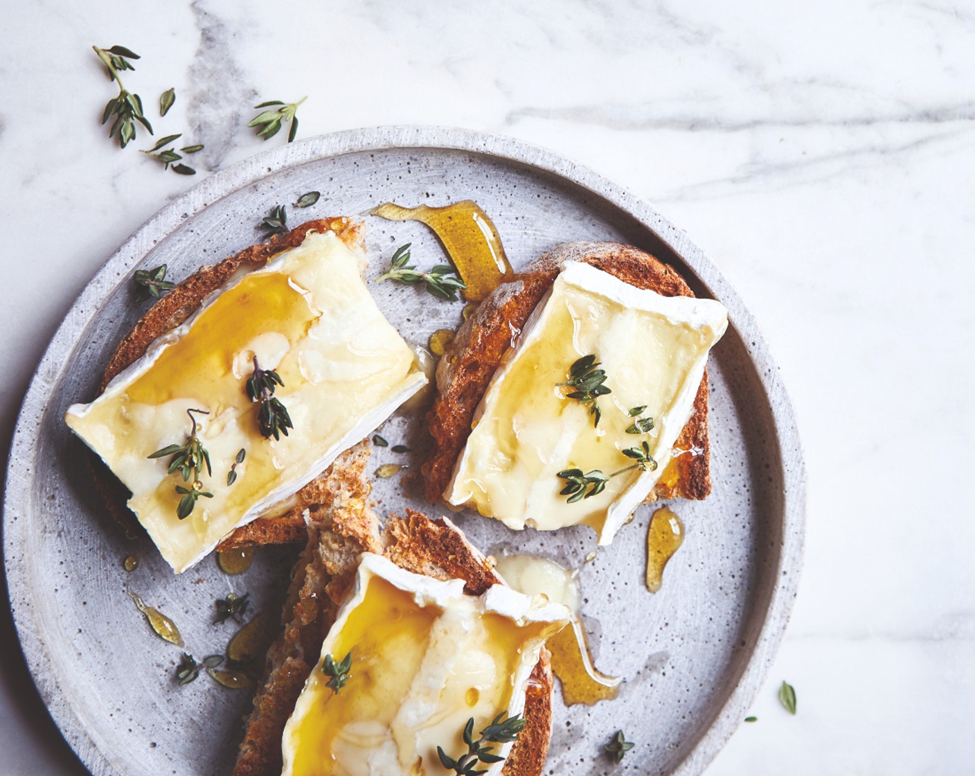 step 2 Top each piece with a slice of truffle brie (1), then scatter over a few fresh thyme leaves (1 handful). Place back under the grill until bubbling. Finish with a drizzle of honey (to taste).