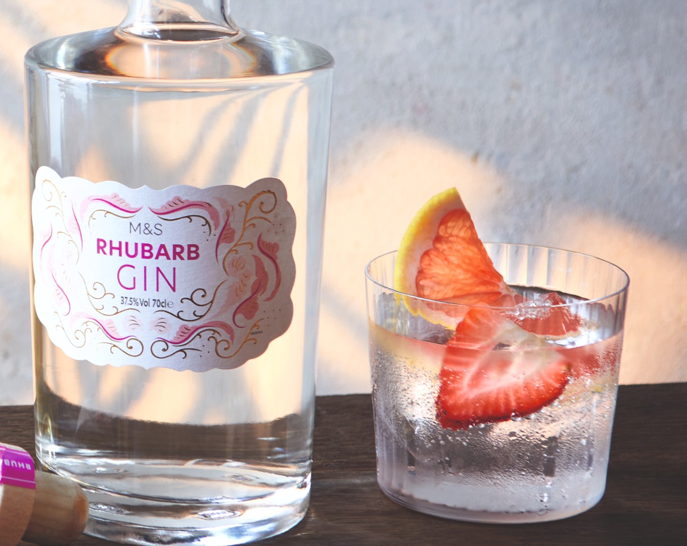 step 2 Top up with the tonic water (150 ml) and garnish with the M&S British strawberry (1) and pink grapefruit (1 slice).