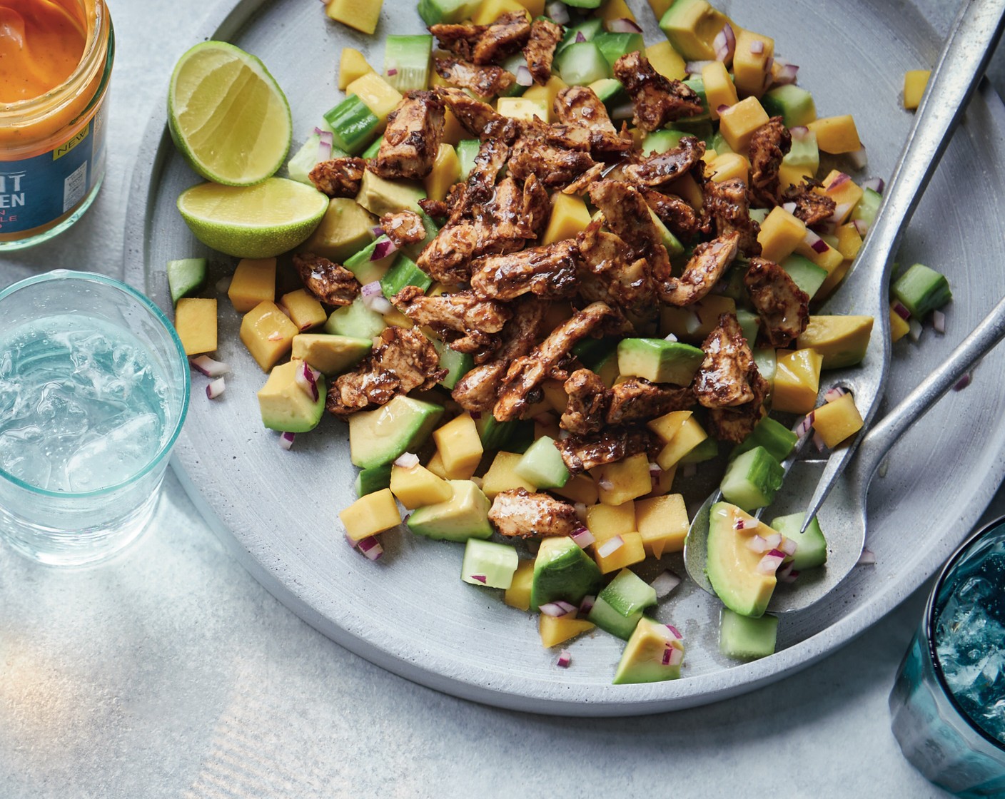 step 2 Mix together the avocado (1), mango (1), cucumber (1/2) and onion (1/2) in a large bowl. Divide between serving dishes and top with the jerk-coated no chicken pieces. Finish each dish with a good squeeze of lime (1/2).