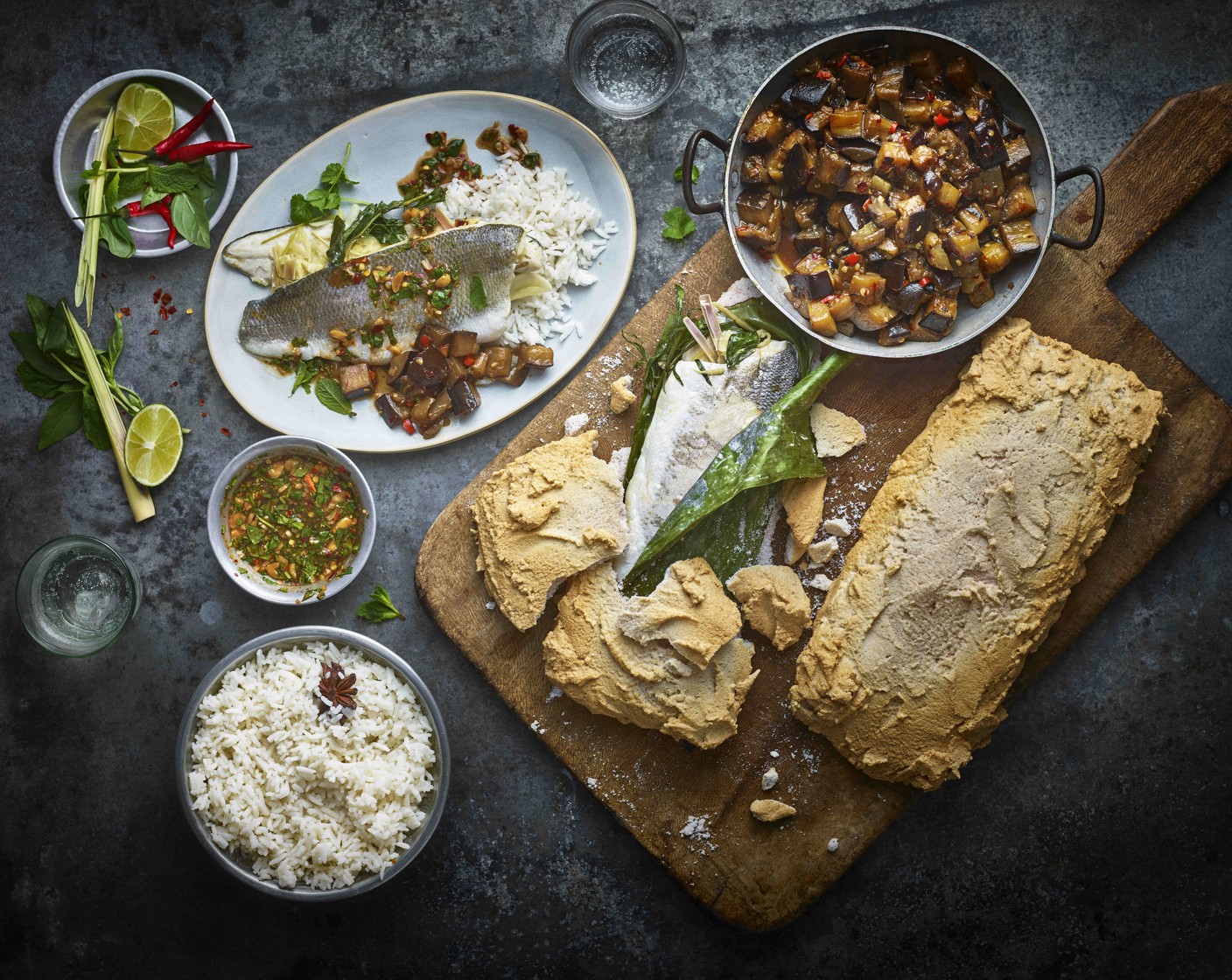 step 9 To serve, either unwrap the foil parcels or break open the salted meringue, open the banana leaf and remove the fish. Serve each piece of fish with some of the rice and aubergines, and the dipping sauce drizzled over.