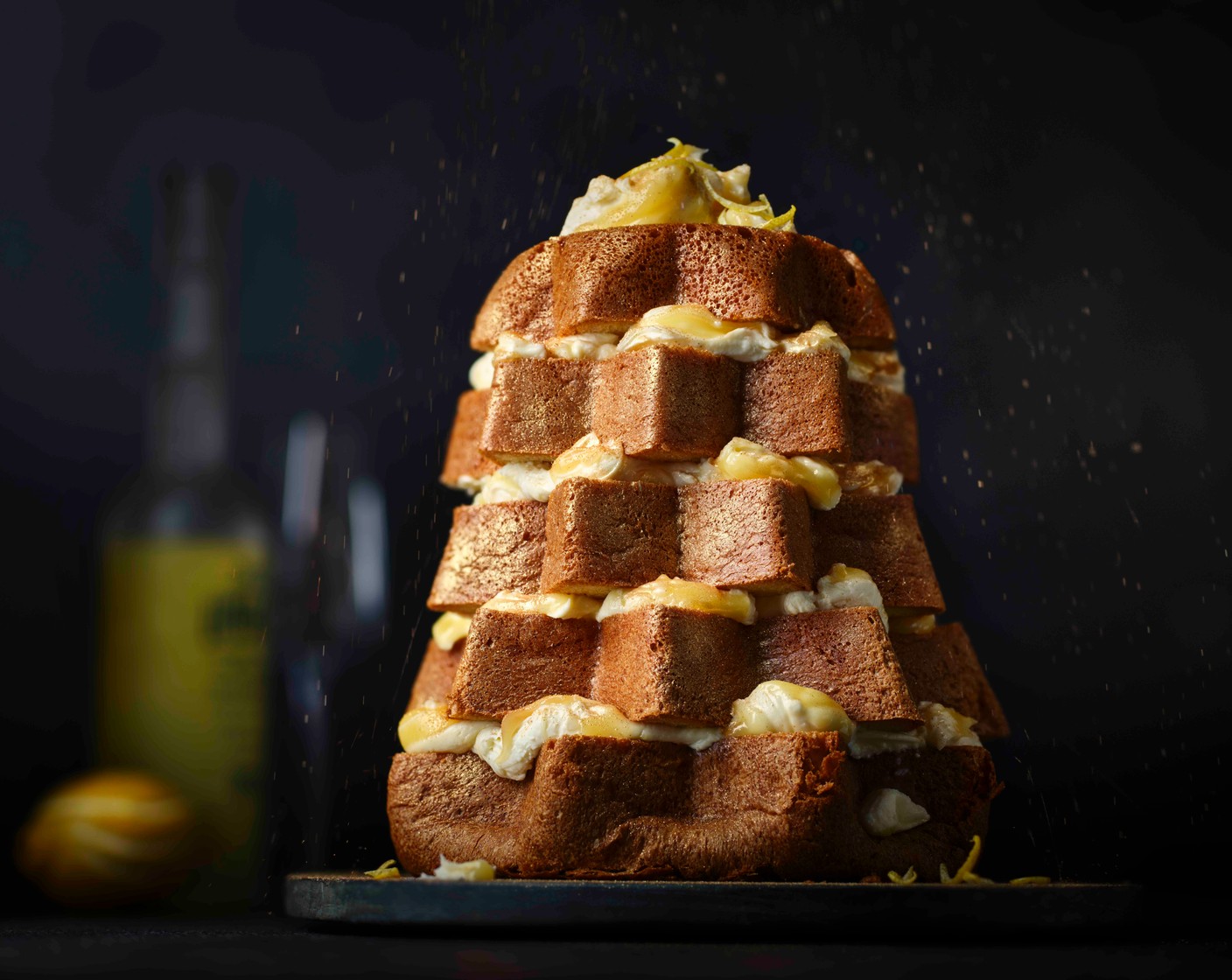 step 4 Finish with a dusting of edible gold dust (1 tsp) and an extra sprinkle of icing sugar. Finish with a grating of the remaining lemon zest (1/2).