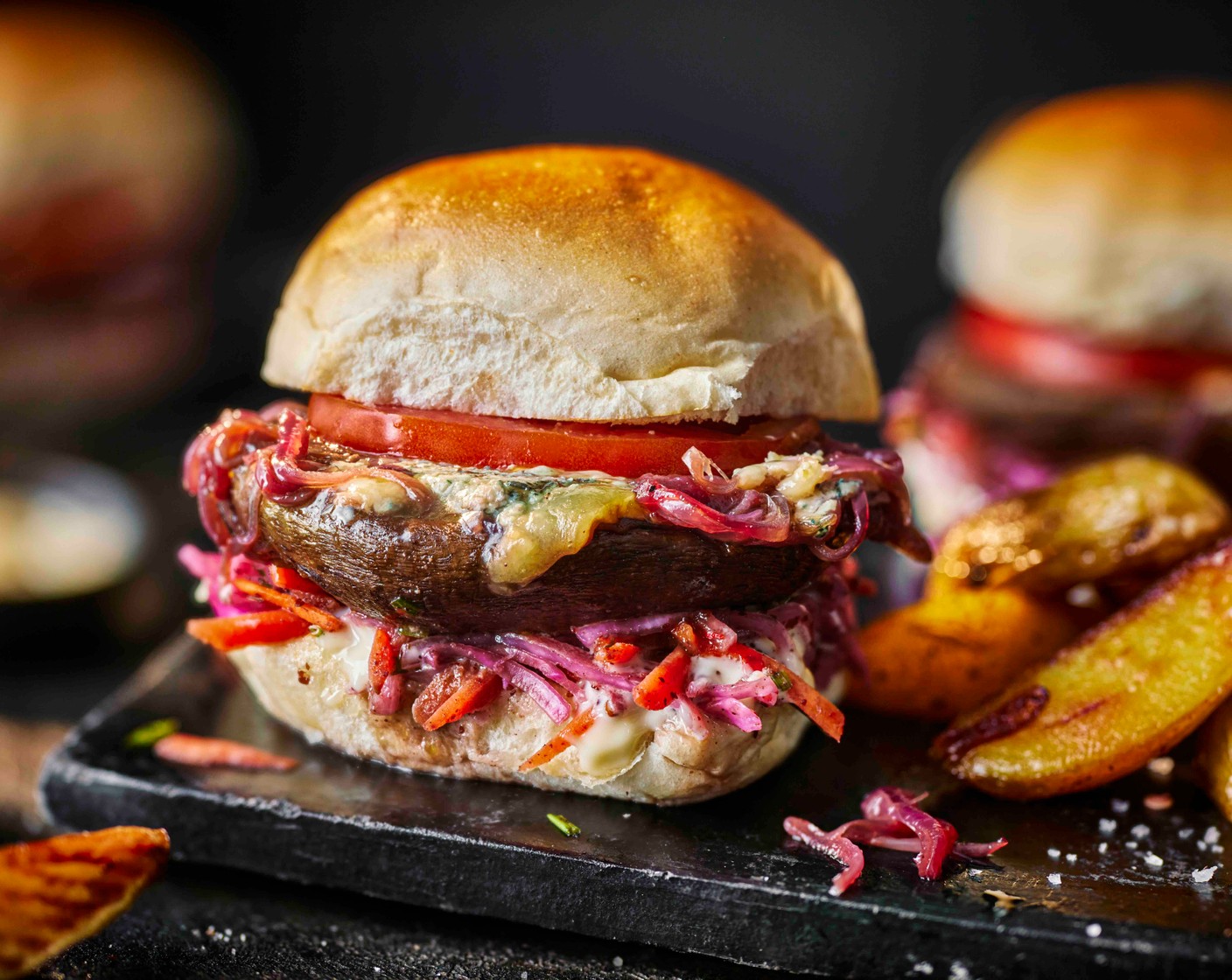 step 4 Toast the burger buns (4) in a dry pan for a minute on each side. To assemble, spoon the slaw (1 pack) onto the burger buns, top with a slice of tomato (1), the mushroom and fiery pickles (as needed). Serve with the wedges on the side.