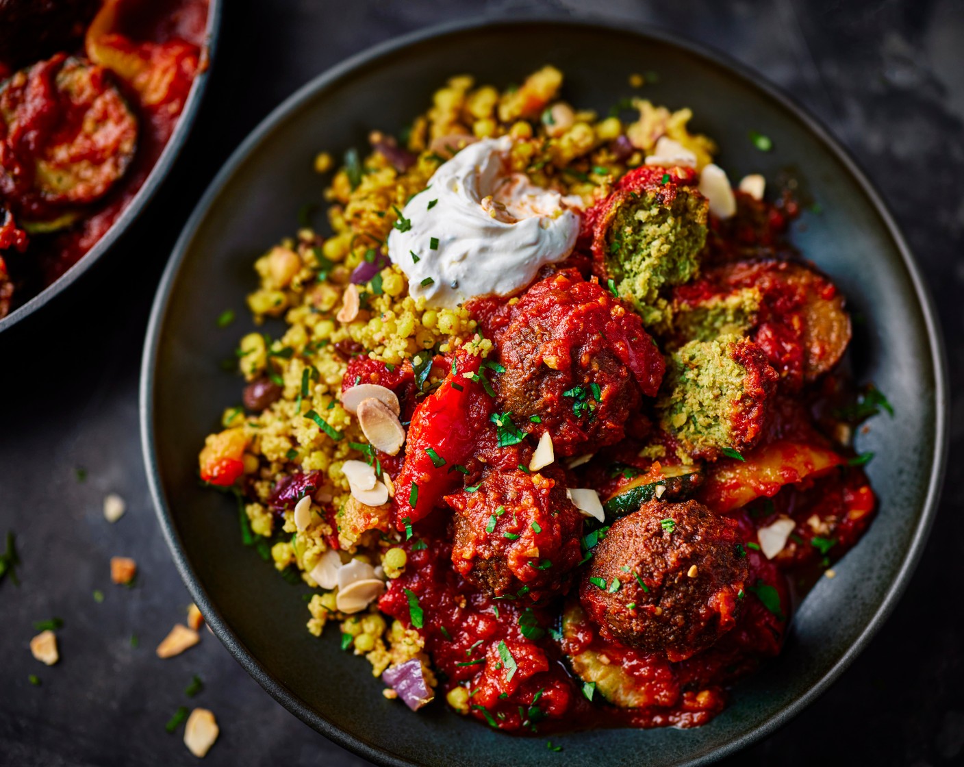 step 4 Serve alongside the couscous (450 g), topped with a dollop of labneh (as needed), and a sprinkling of parsley (15 g) and toasted almonds (1 handful).