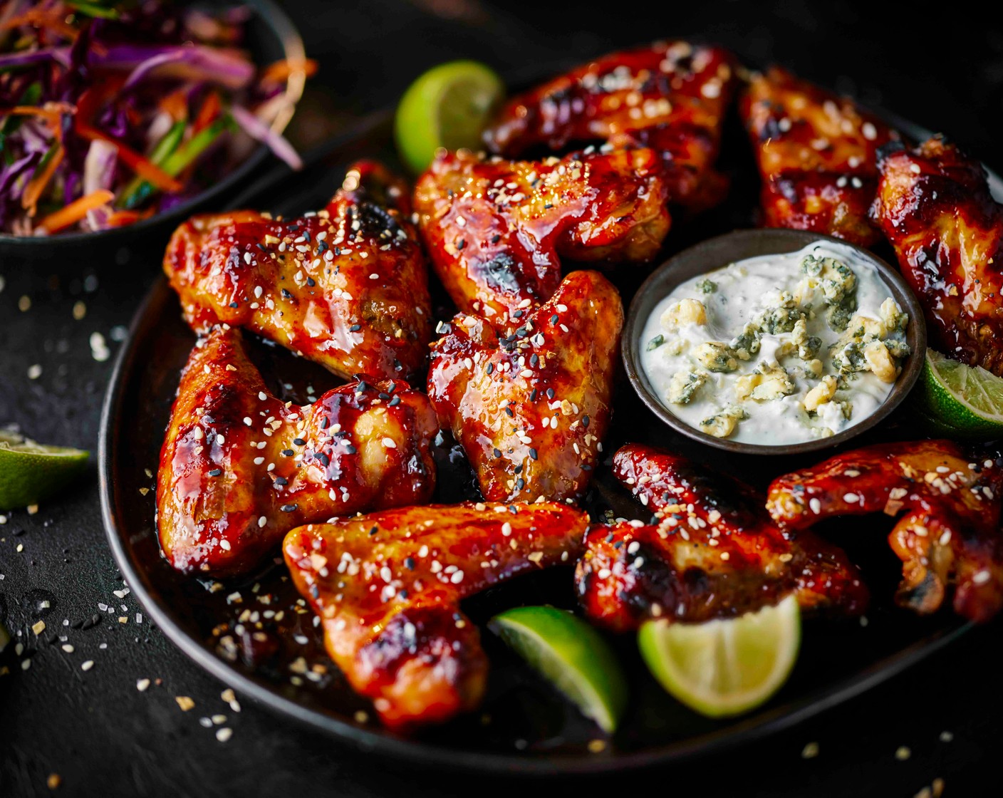 step 5 Sprinkle the sesame topper over the cooked wings and serve with the slaw and blue cheese dip.