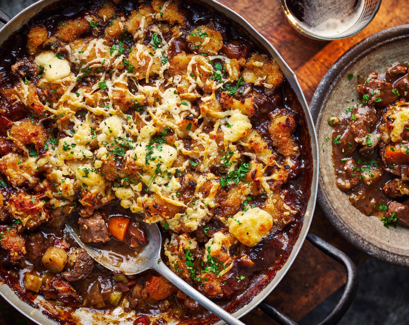 step 5 Once the stew has simmered for 25 minutes, top with the croquette halves, then scatter over the grated cheddar (80 g). Bake in the oven for 35 minutes, until the top is golden brown.
