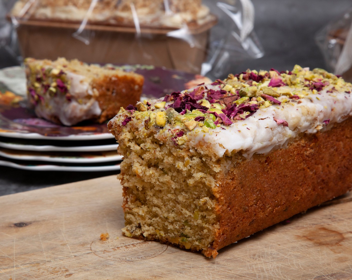 step 9 For the glaze, mix the sifted icing sugar (150 g) and lemon juice (1/2) until the sugar has dissolved. If it’s too thick, add a little more lemon juice. Pour over the cooled loaf and scatter with rose petals (1 tsp) and chopped chopped pistachios (2 tbsp).