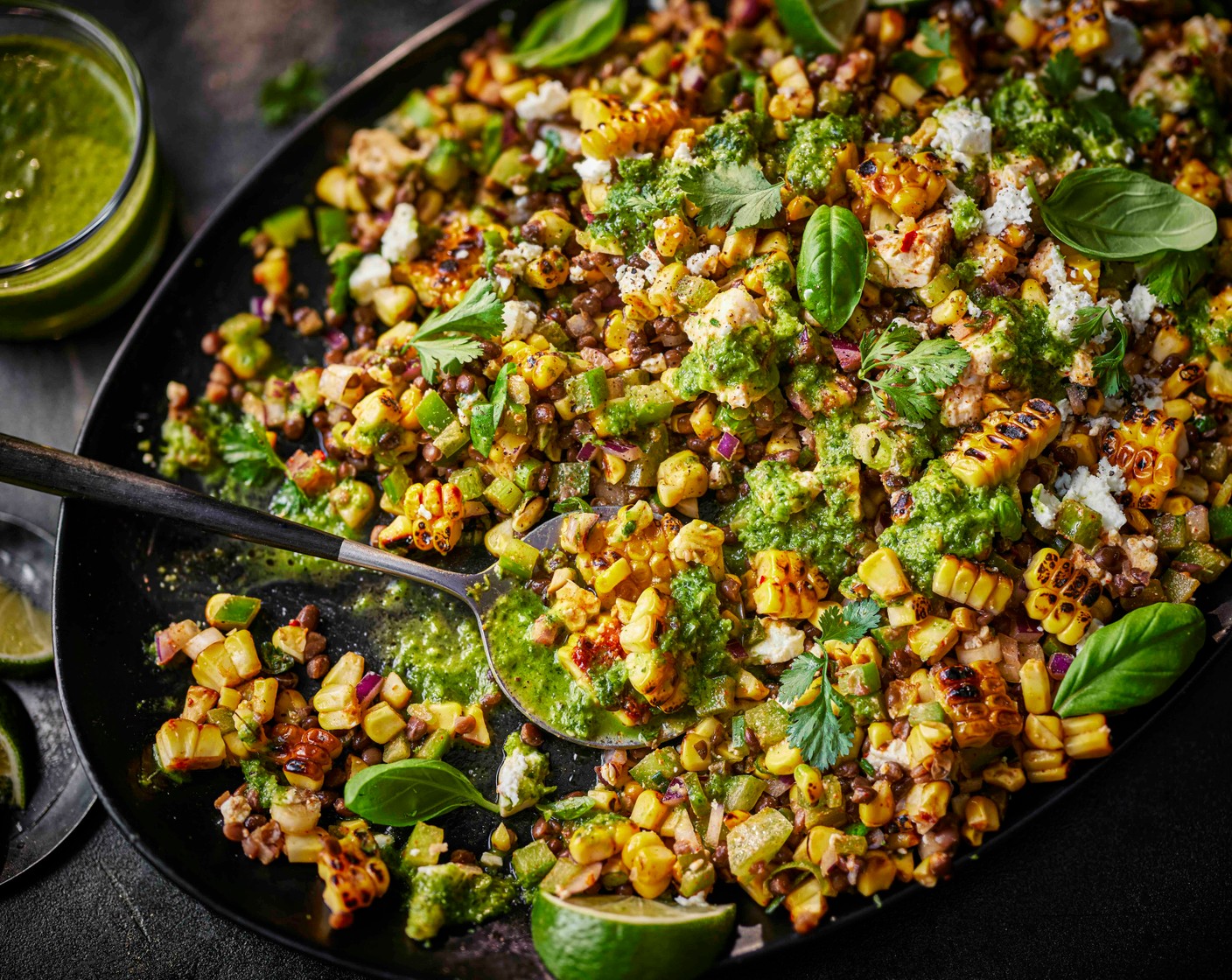 step 3 Tip the drained lentils (500 g) into a large bowl and add the charred corn, red onion (1), green pepper (2), feta (100 g), yogurt (1 tbsp), lime juice (1) and coriander (10 g). Stir to combine, then spoon onto a serving platter. Drizzle over the dressing and finish with a little extra feta, herbs and lime zest, if you like.