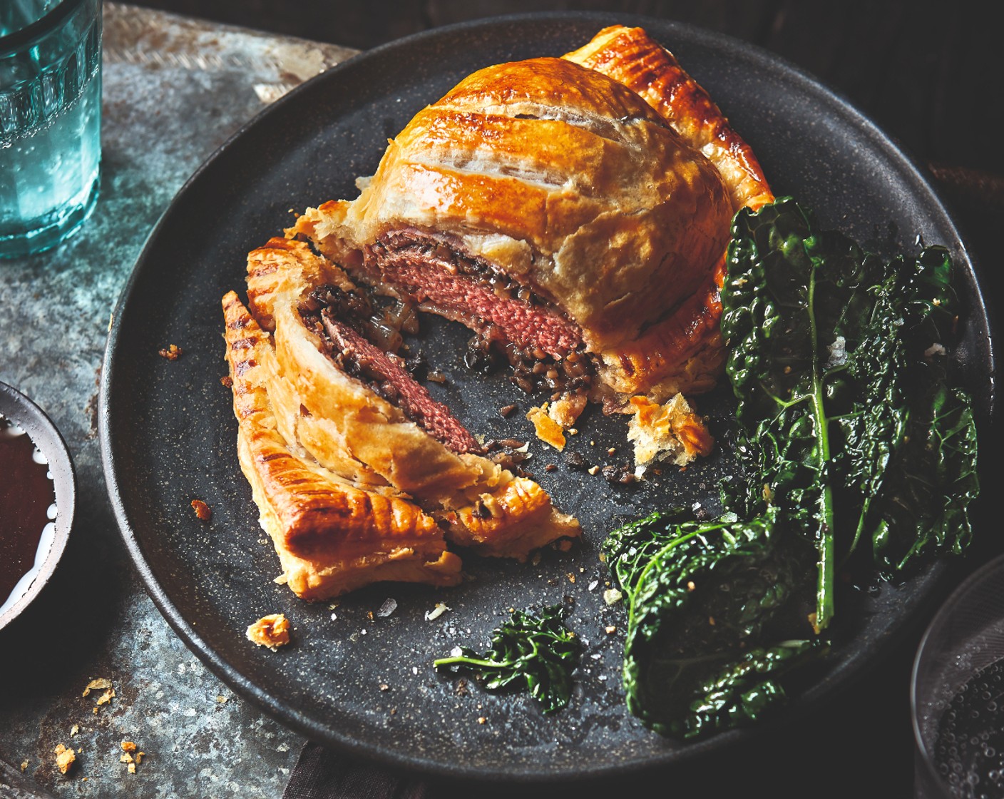 step 8 Heat the red wine sauce according to the pack instructions and serve with the Wellingtons and cavolo nero.