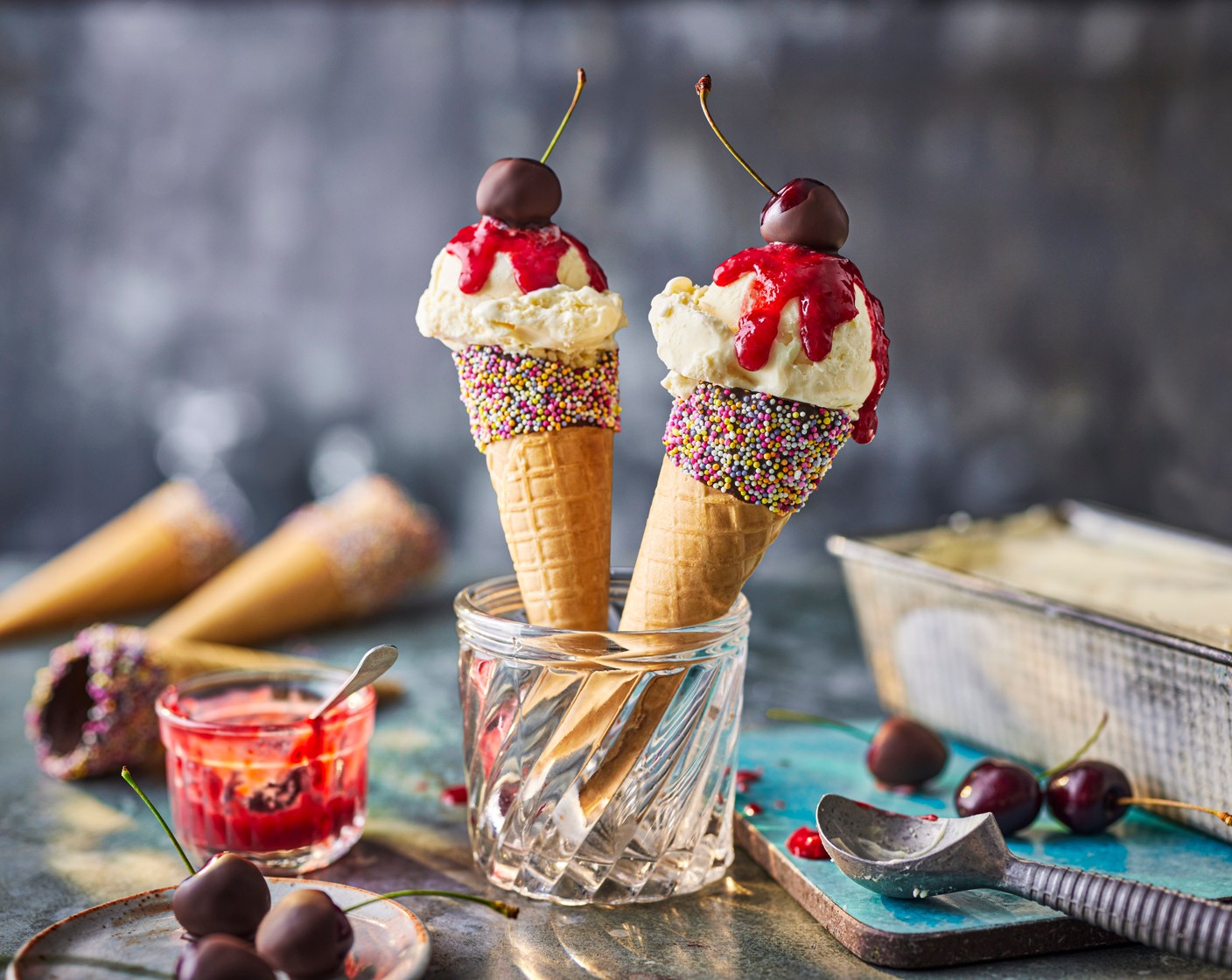 step 3 Serve the ice cream in the cones (12), with a drizzle of berry coulis (as needed) and a chocolate-covered cherry placed on top.