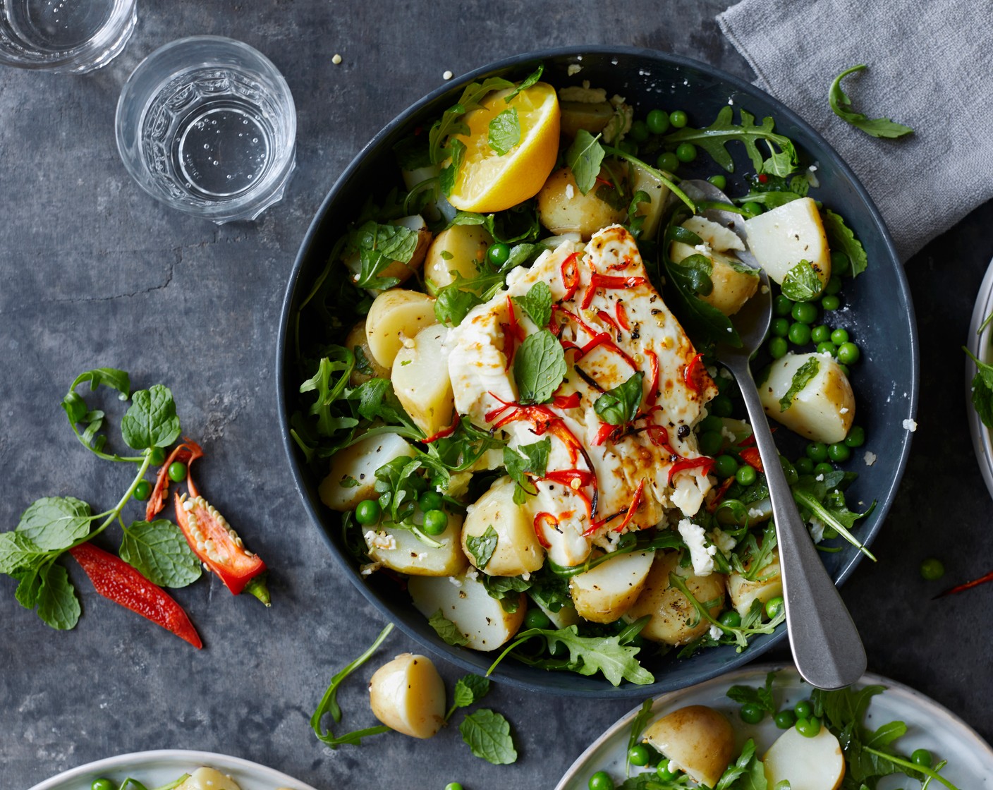 step 8 Tumble the dressed potatoes with the rocket (40 g), place in a shallow serving bowl and carefully place the whole feta onto the potatoes or break it into pieces and arrange on the potatoes. Finish with extra mint and chilli if you like.