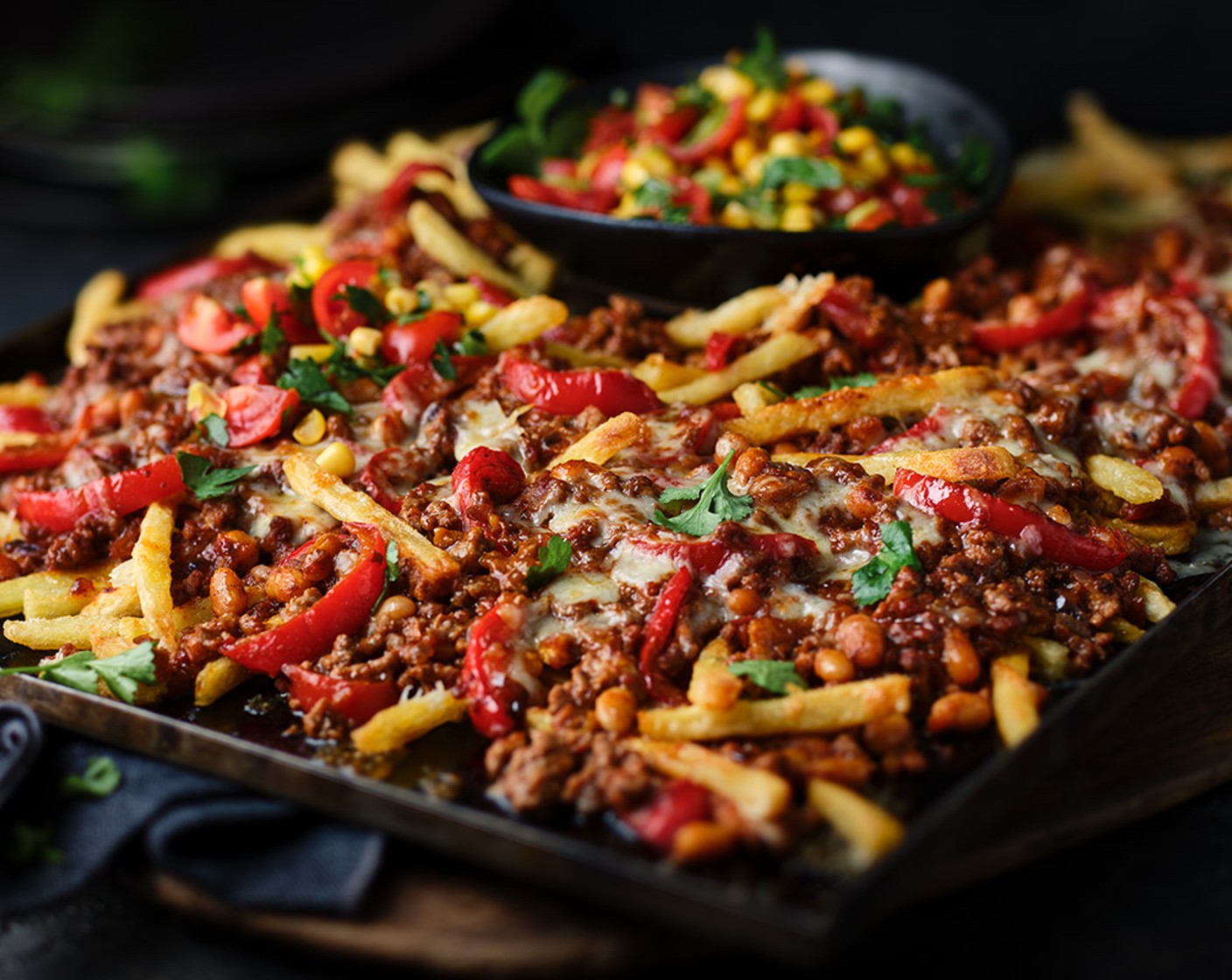 step 7 Top the chilli fries with the cherry tomato salsa and dig in.