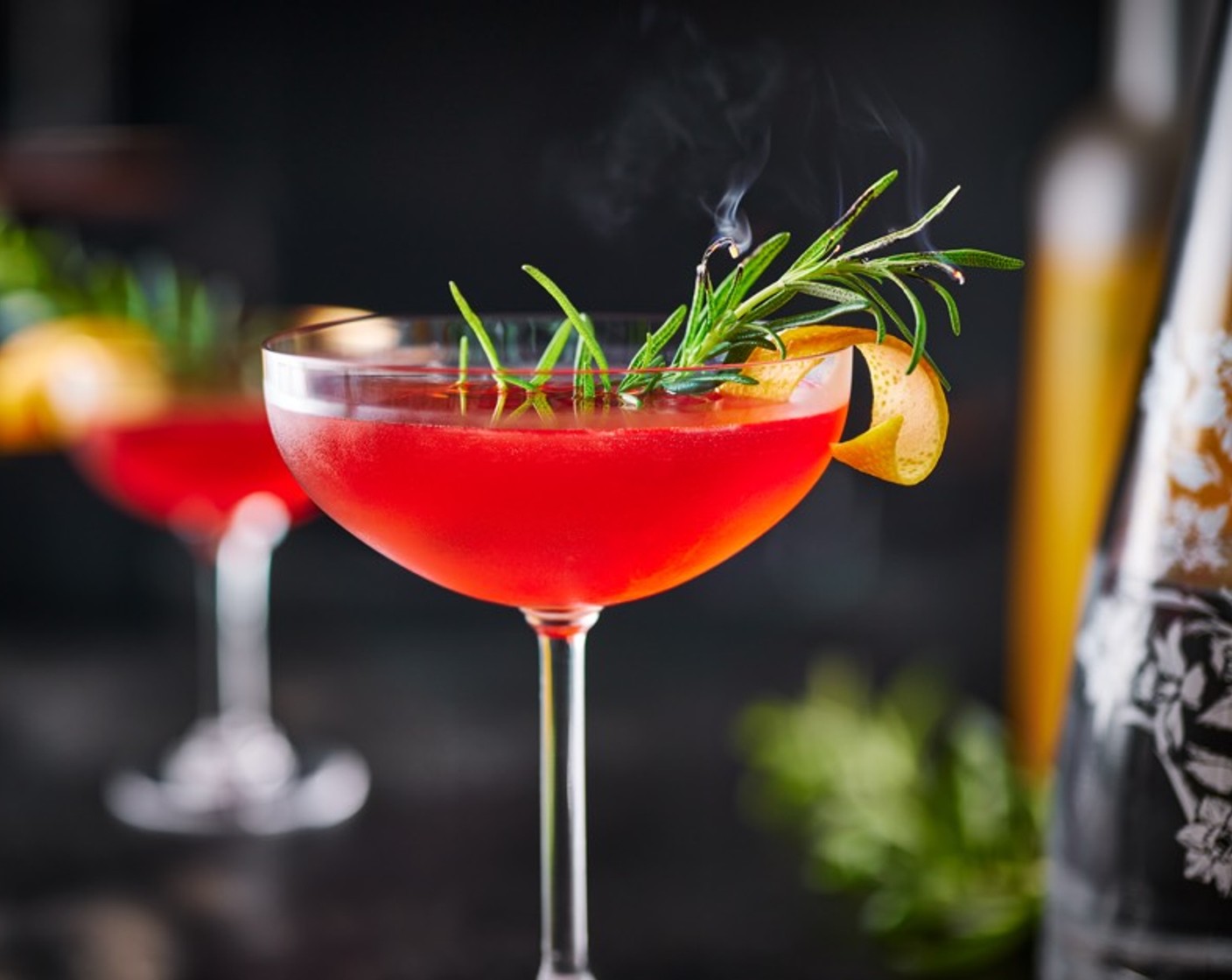 step 2 Strain into a chilled coupe or martini glass. Garnish with a twist of orange peel (1)  a sprig of rosemary sprig (1) to serve.