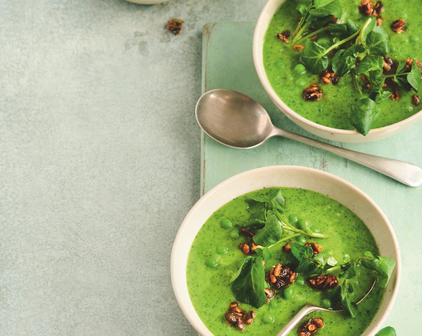 step 4 Stir in the reserved peas and return to the heat. Bring the soup back up to a simmer, then serve in warmed bowls topped with the honey-spiced seeds and the reserved watercress.