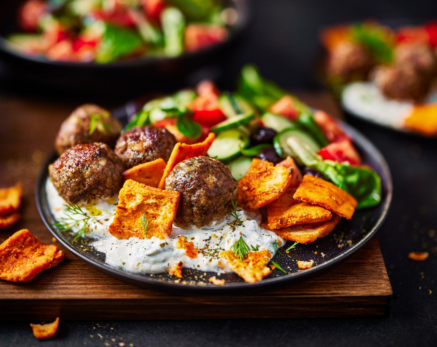 step 5 Spread the feta dip into four bowls and top with the turkey meatballs, the salad and a handful of red pepper pitta chips (150 g).