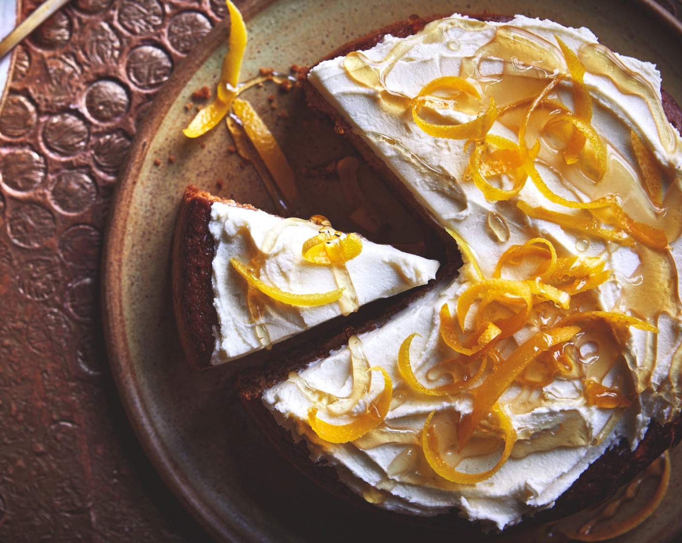step 5 Place the cooled cake onto a board or plate and spread or pipe the icing over the top, then scatter over the orange zest (1) and drizzle over the honey (1 tbsp).