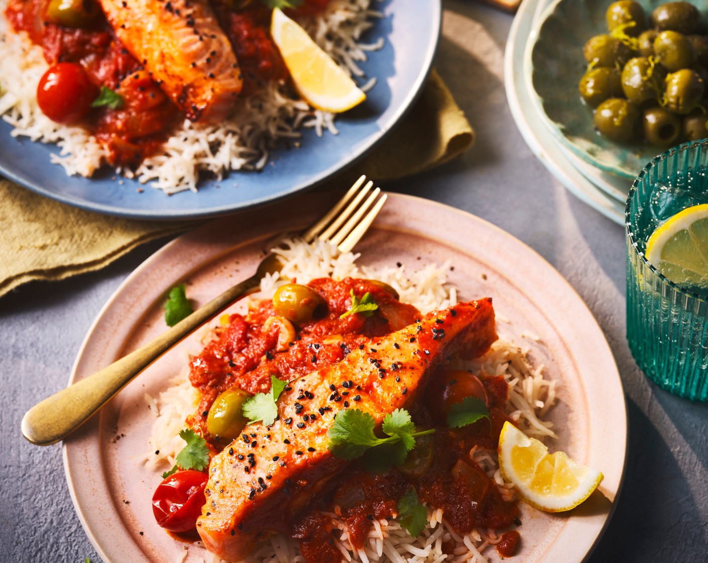 step 5 Arrange the salmon fillets and sauce over cooked basmati rice (as needed). Garnish with nigella seeds (as needed), fresh coriander (1 handful) and lemon wedges (1).