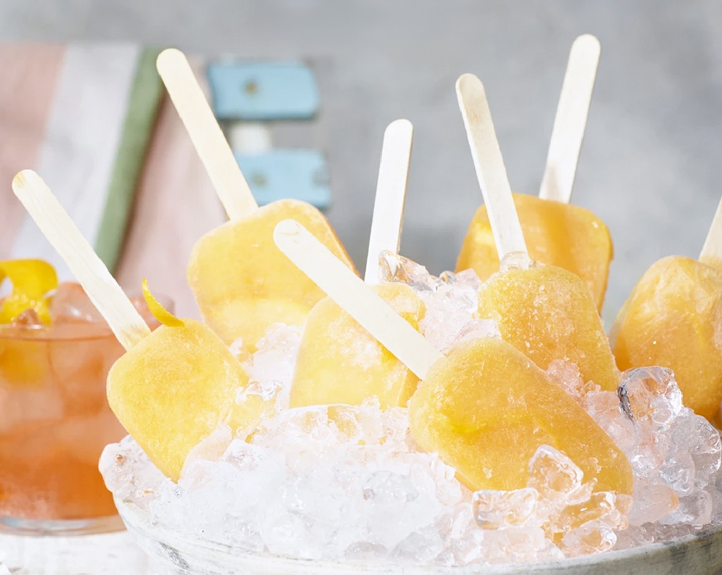 step 2 Place a slice of orange (4 slices) and a lolly stick into each of the mould sections. Freeze until solid, then remove from the moulds. If the lollies are tricky to remove, briefly dip the moulds in hot water to loosen.