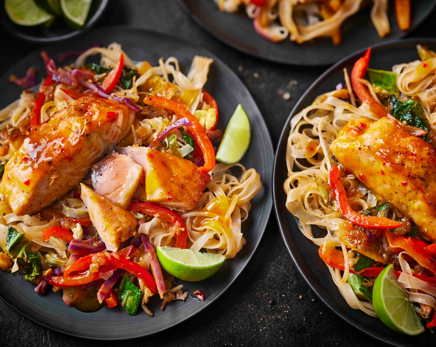 step 5 Divide the noodles between four bowls. Top with the sticky salmon fillets and spoon over any juices from the baking tray. Serve with the lime wedges (1) on the side for squeezing over.