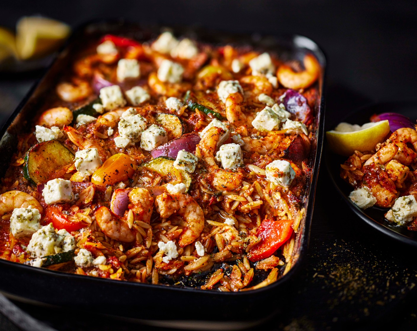 step 5 Scatter over the remaining Greek seasoning (1/3 tbsp), the diced feta and oregano (1 pack) and drizzle with ½ tbsp of olive oil. Mix it all together and serve with the lemon wedges (1).