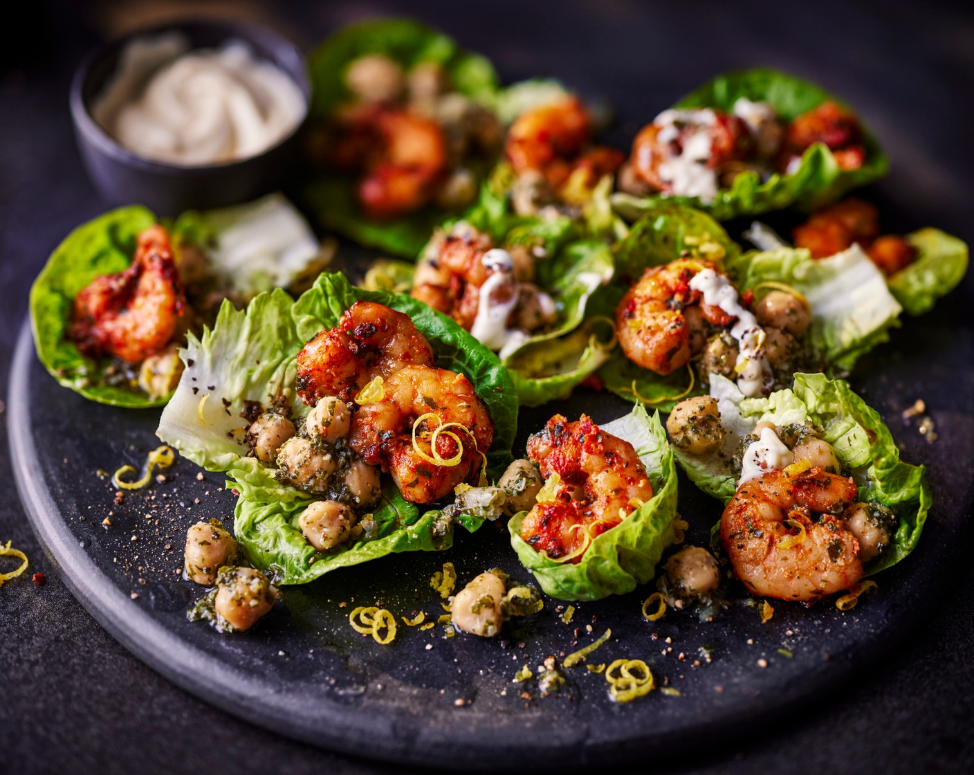 step 4 When you’re ready to serve, add the chickpeas to the lettuce cups, topped with the ‘nduja prawns (remove from their skewers) and a drizzle of Sicilian lemon mayo (to taste), a grating of lemon zest (1) and a squeeze of lemon juice.